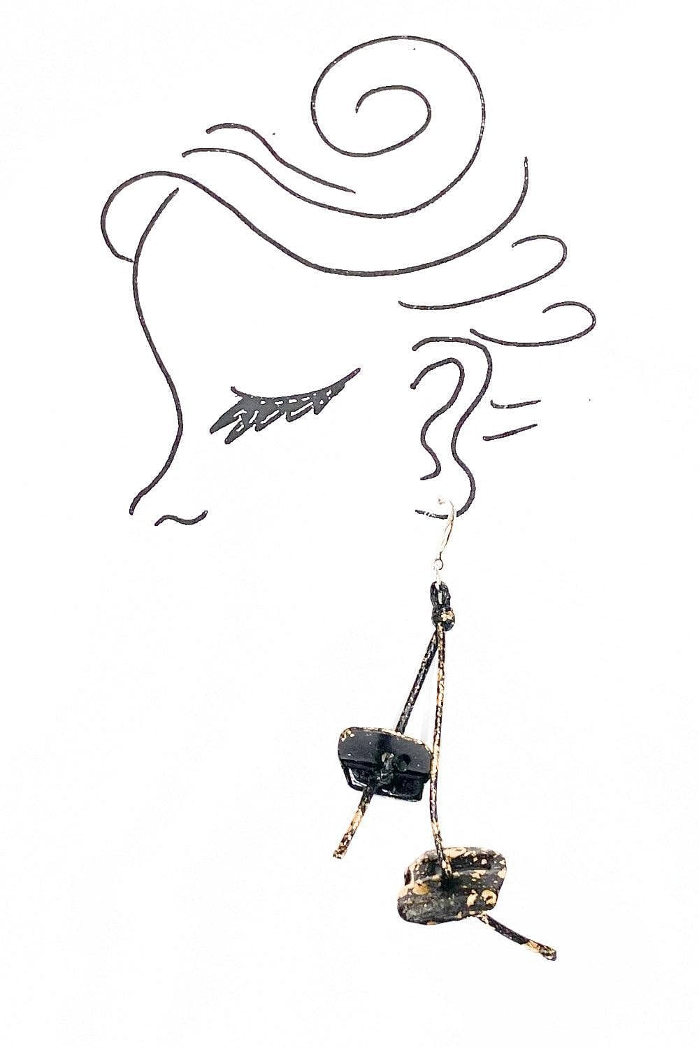 Hand made dangle earring with colored black and gold. Curves as they dangle from the earlobe.