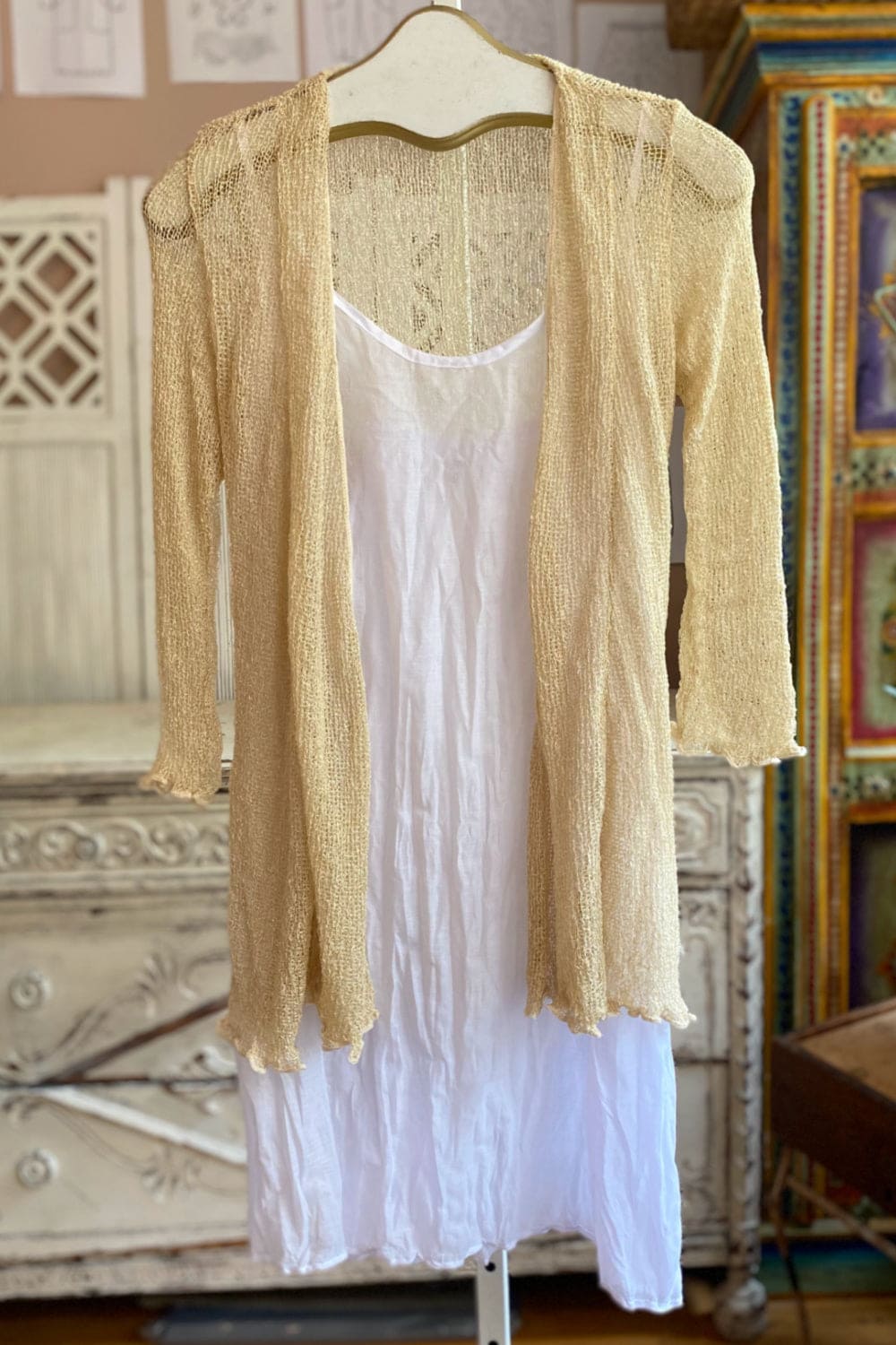 Thin knit summer sweater in a pale straw color.