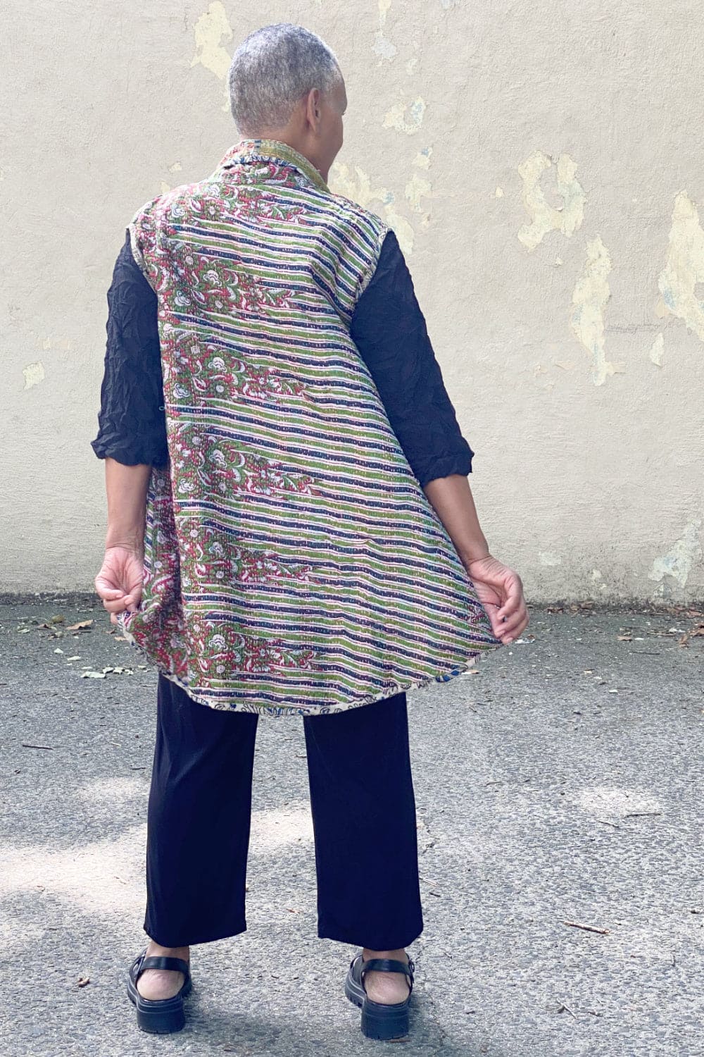 Back view of Reversible silk vest with Kantha stitching worn on an older woman.