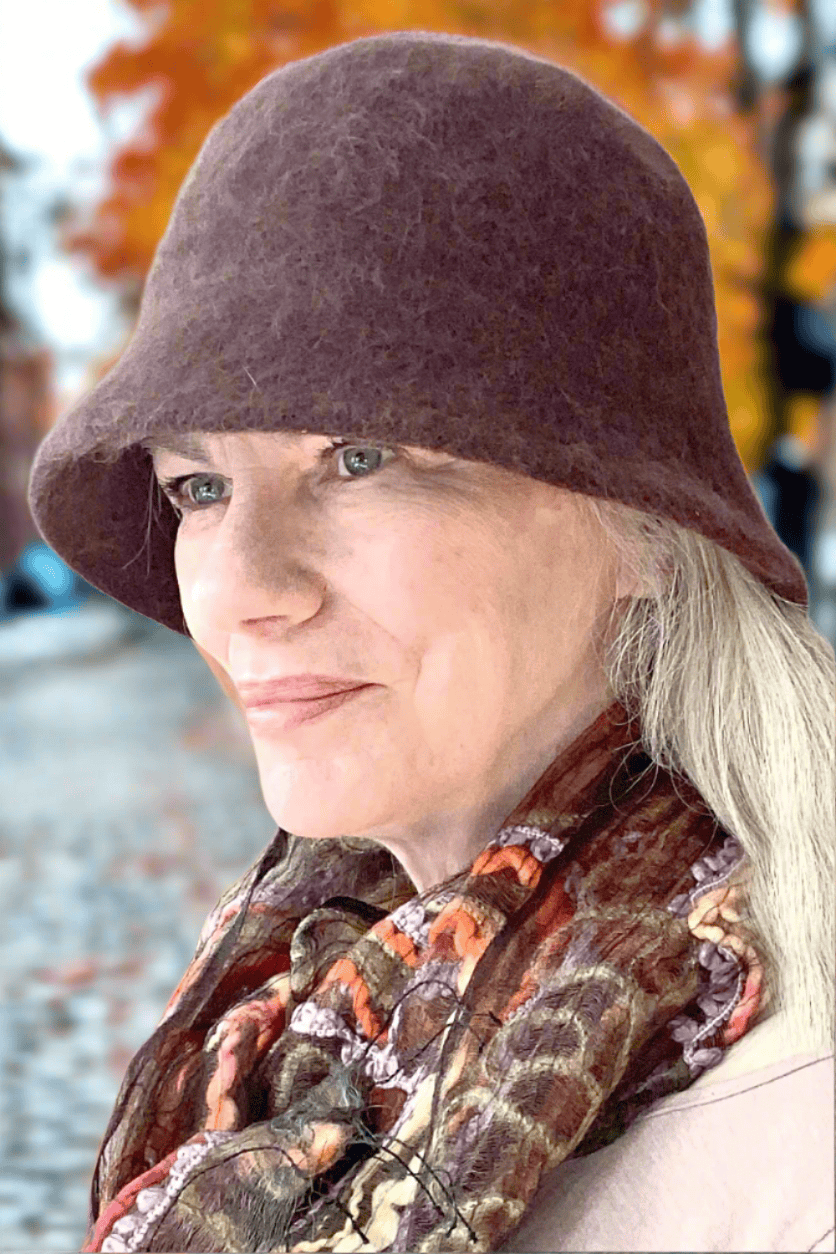 Brown textured medium brim hat with brown patterned silk scarf.