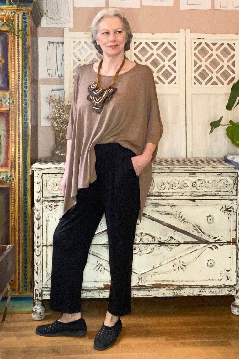 Black loose fit ankle pants worn with an oversized mocha colored tunic.
