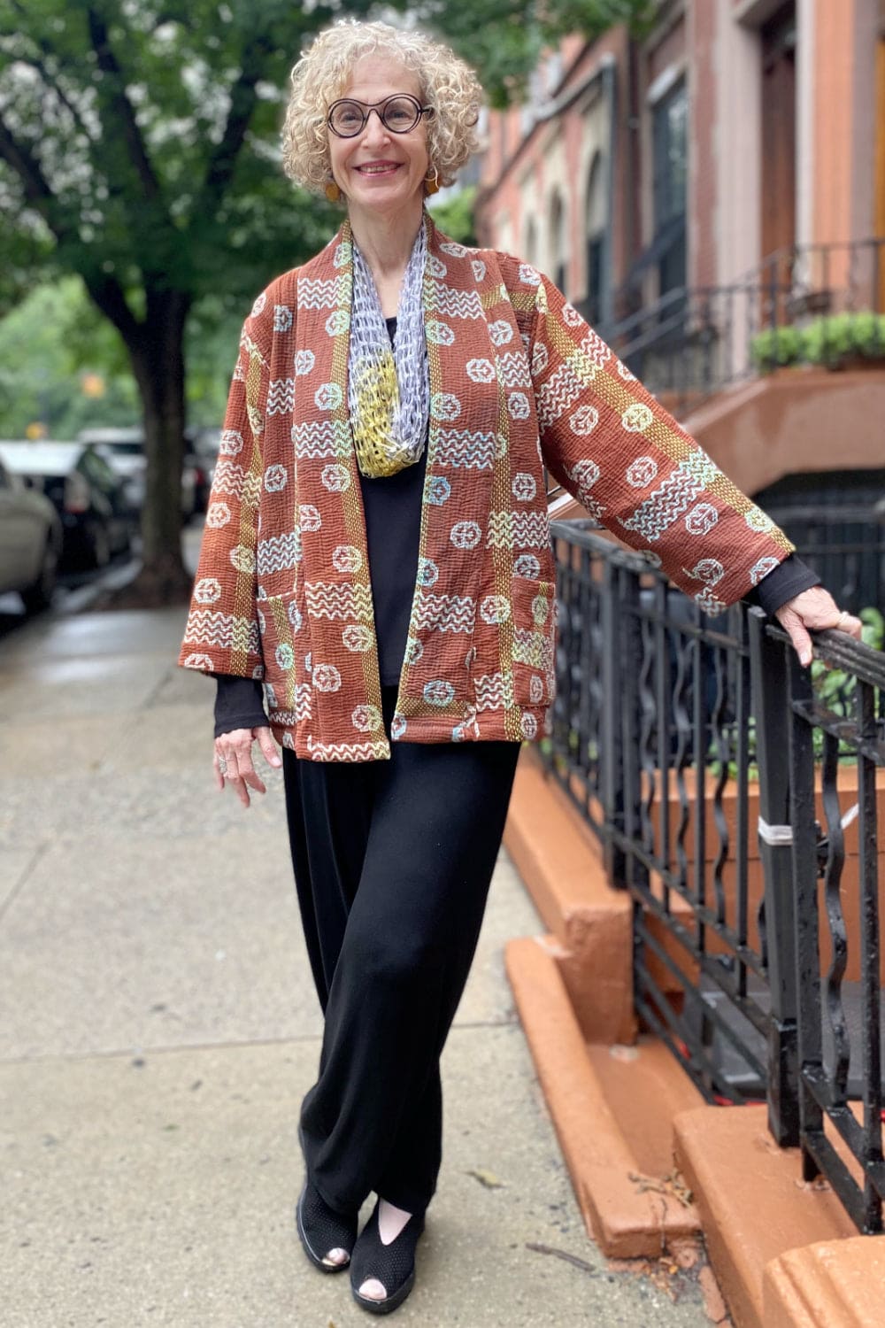 Smiling older womn wearing the Brown -Lavender Kantha Jacket.