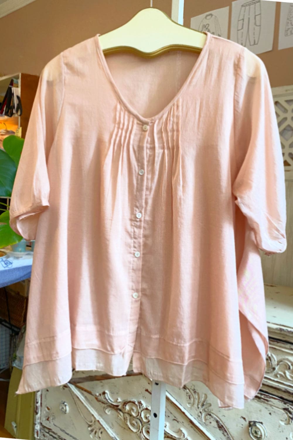 Lightweight cotton aline blouse with pearl buttons in a pretty blush color.