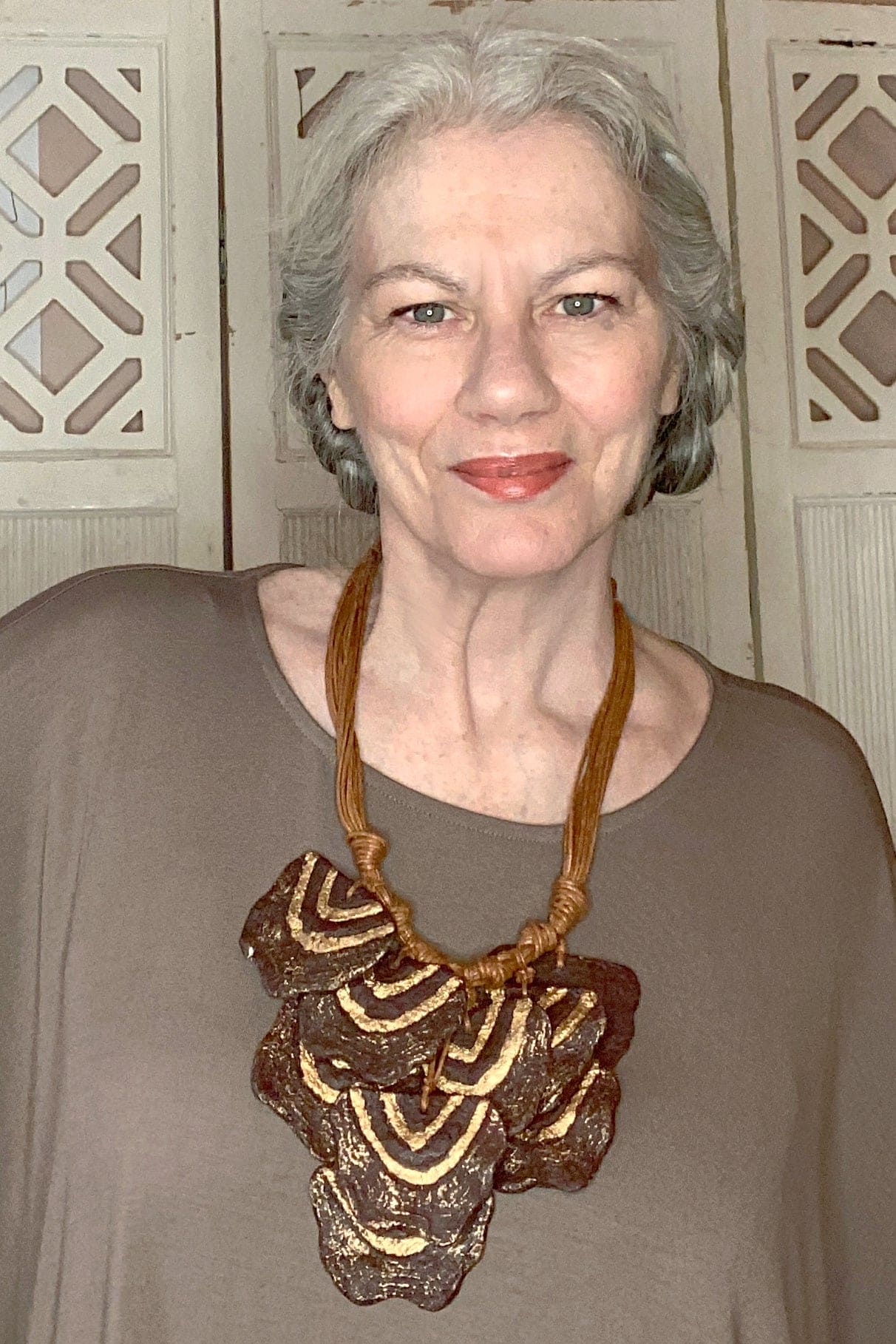 Funky paper mache statement necklace in gold and brown tones.