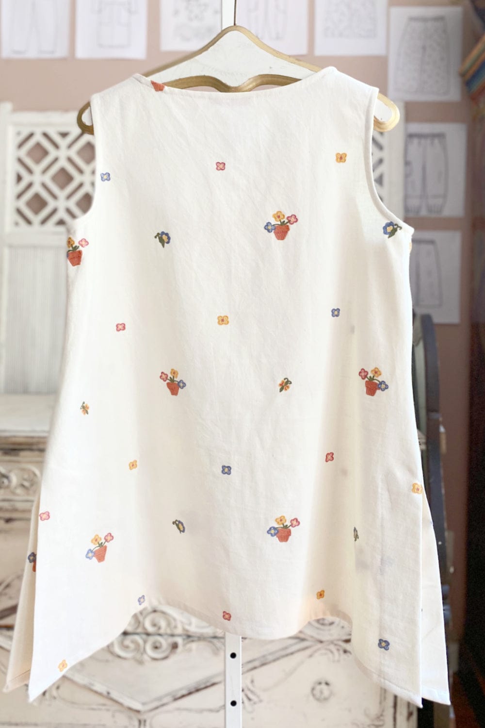 Back view of women's long cotton tunic with sweet floral stitching.