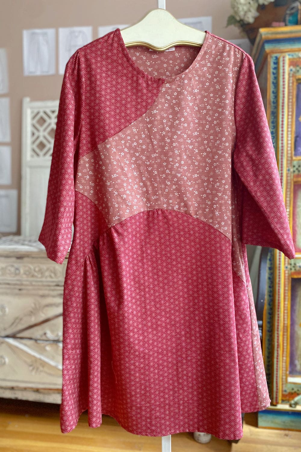 Pretty rose colored floral tunic dress with long sleeves and gathering detail.