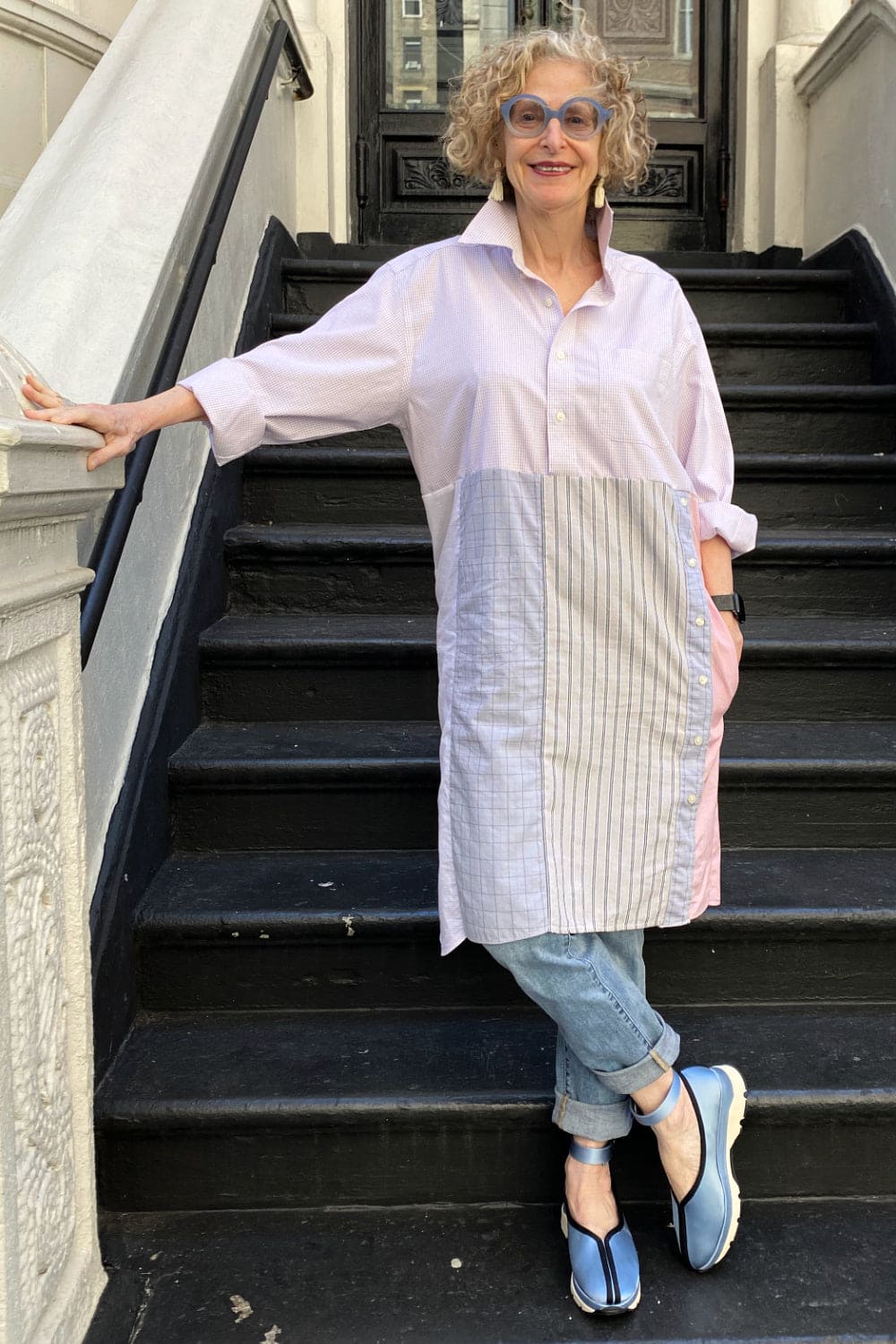 Shirt dress worn over jeans.