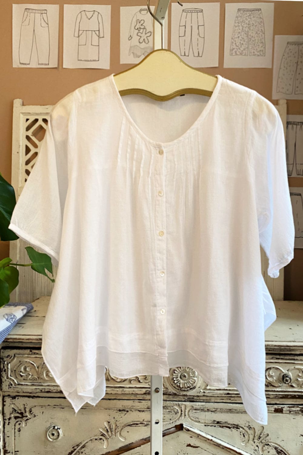 White lightweight cotton blouse with layered bottom.