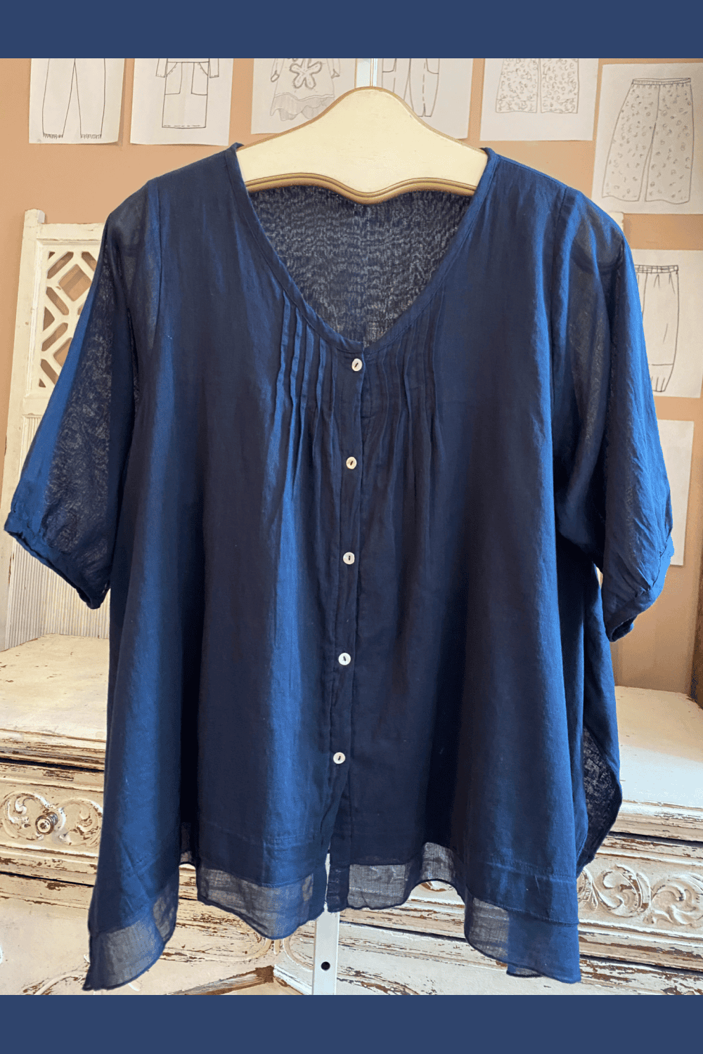 Navy blouse with aline cut and three quarter sleeves.