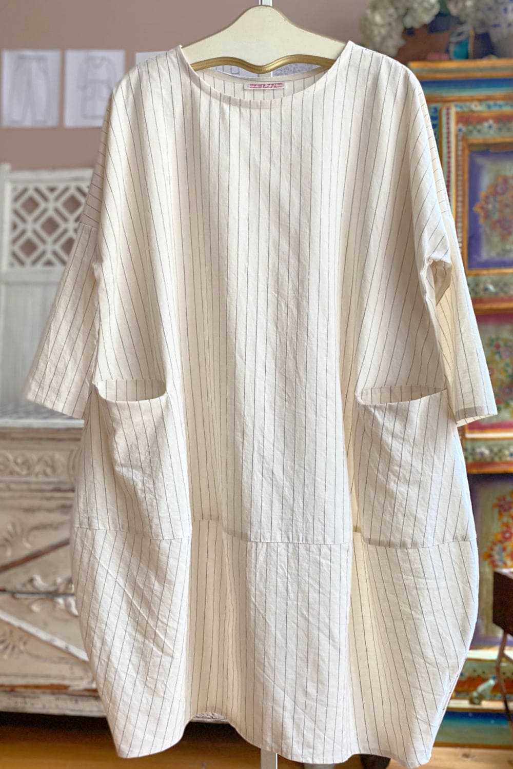 Natural with navy pinstripe linen dress with two front pockests and long sleeves.