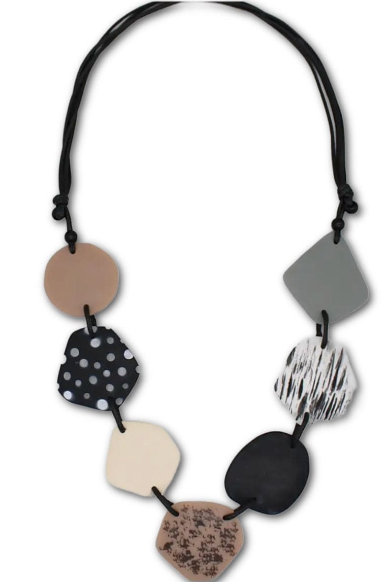 Prints & Plain Necklace with flat odd shaped beads strng on an adjustable black cord.