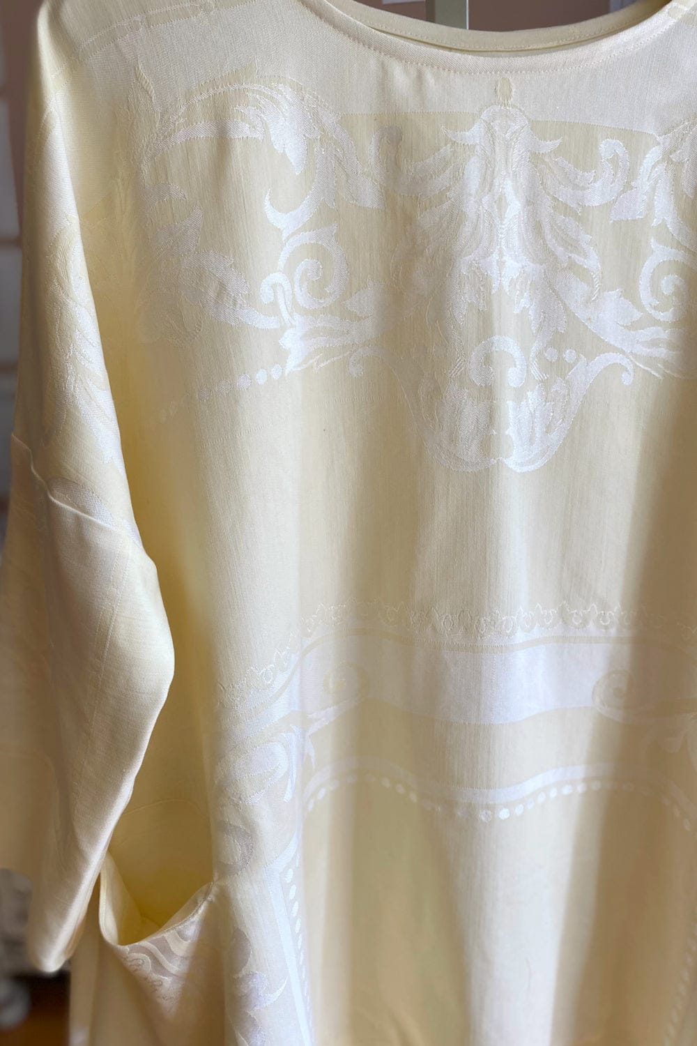 Close up of Pale yellow Vintage Tablecloth dress in damask linen.