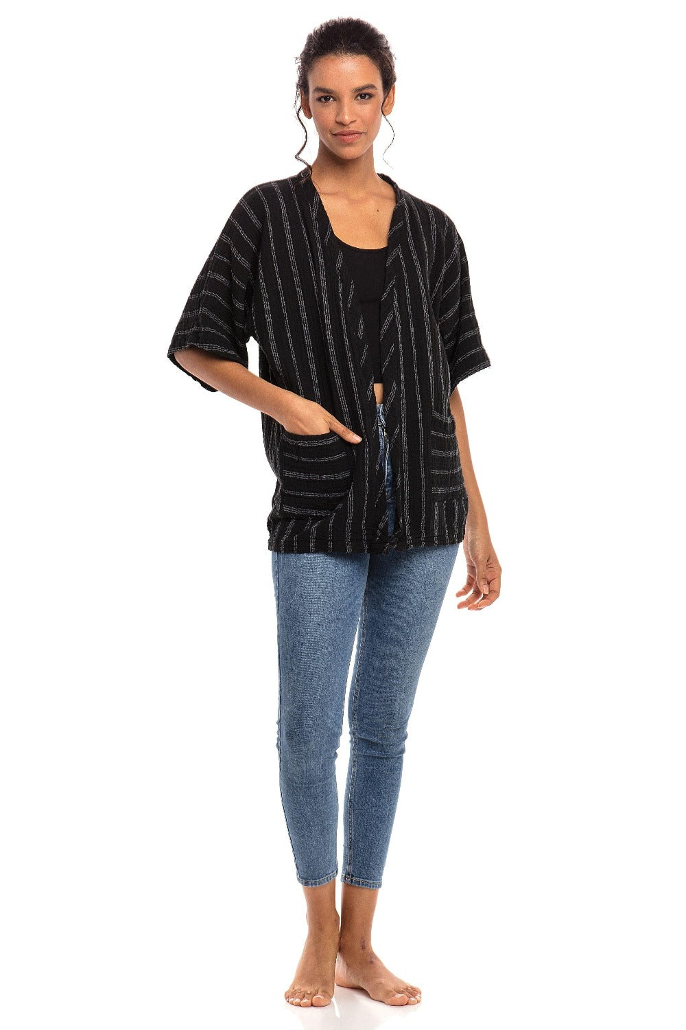 Short Sleeve Open Jacket in a double cotton with a stripe. The woman wearing this black jacket is using one of the two pockets.