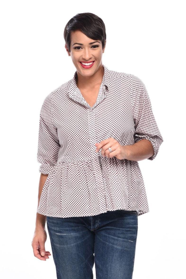 Woman wearing a pretty peplum shape button down blouse with jeans.