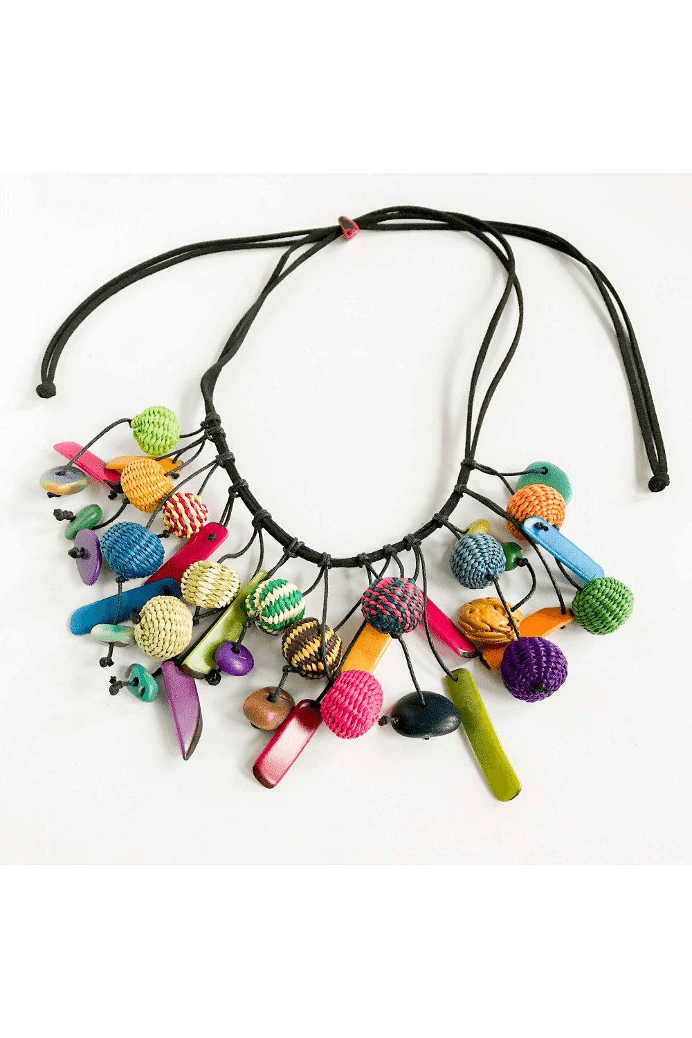 Taqua chips and woven beads strung on a black cord adjustable necklace. Mulit bright colors.