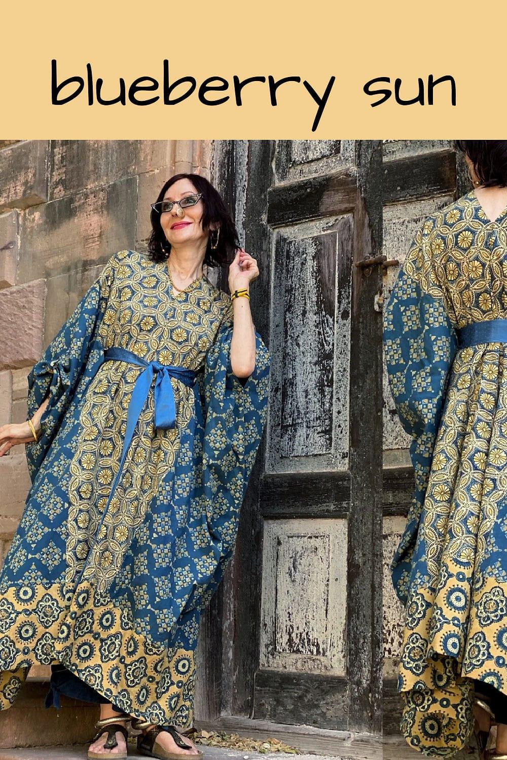 Handprinted Indian Cotton Kaftan in a mixture of colors and patterns. A tied silk sash is bowed just above the waist. 