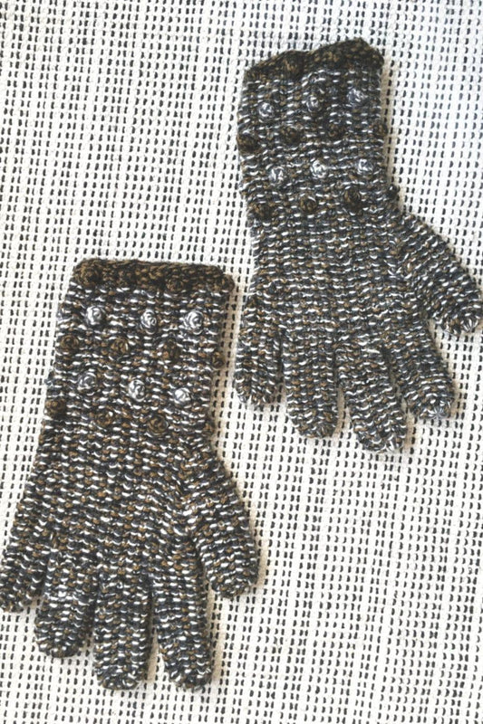 Sweet Pea Alpaca Gloves are a blend of brown and white yarn. They are decorated with tiny balls.