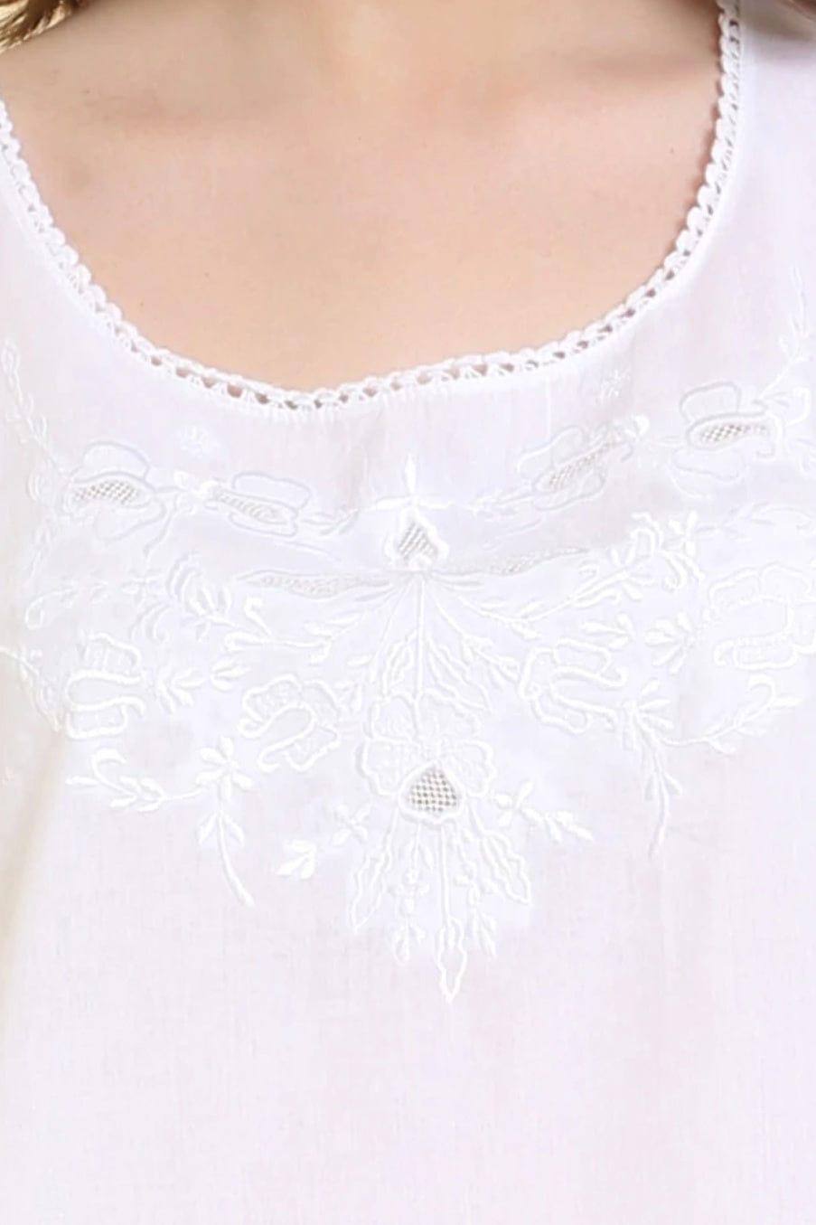 Close up of neckline of white cotton nightgown. Stitching and cutout detail.