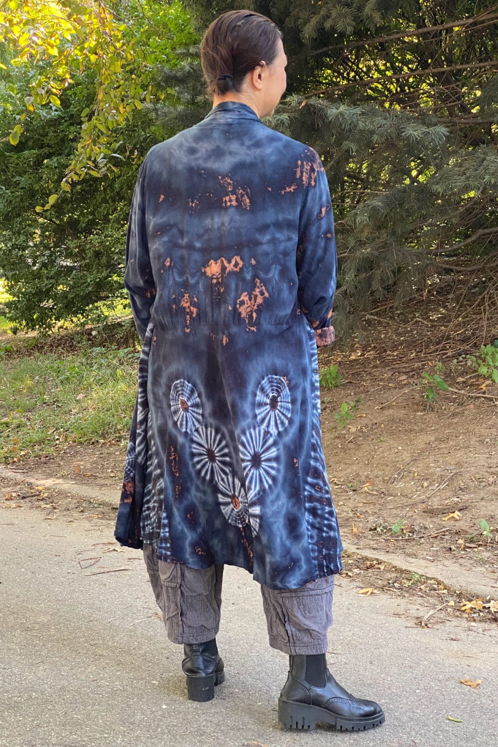 Back view of women's long light weight tie dye jackets in grey blue tones.