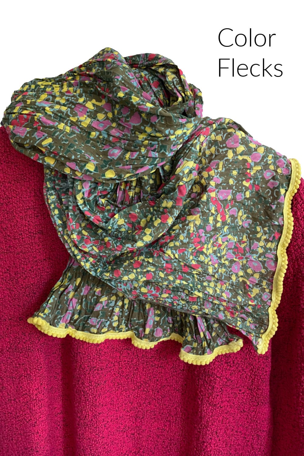 Cotton scarf with pretty color flecks on a green backgroun with yellow textured trimming.