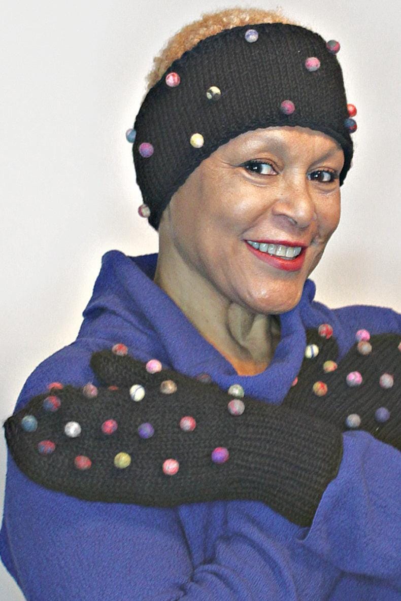 Lined wool mitts decorated with multi colored felted balls. Model is wearing a matching headband.