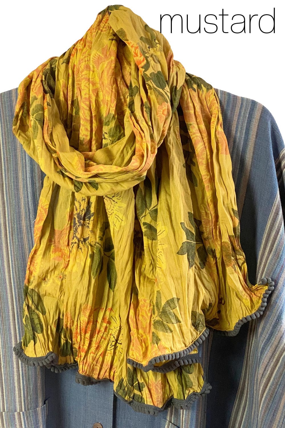 Pretty cotton  mustard color scarf with floral print. Edges are trimmed little textured trim.