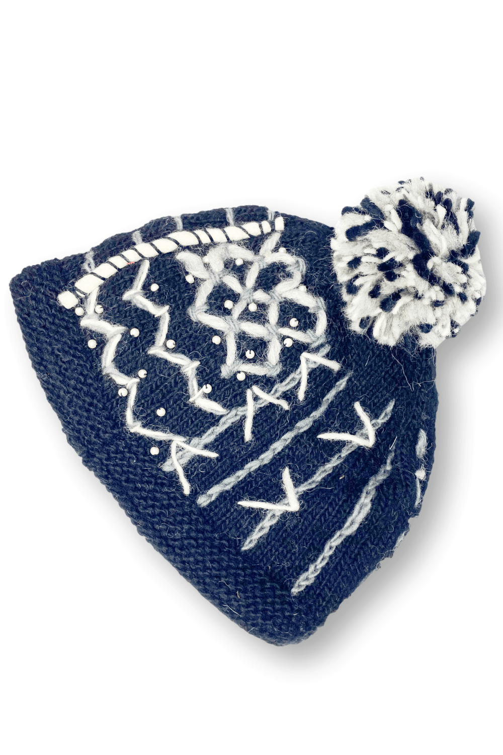 Woman's wool beanie with fleece lining decorated with with stiching and a black and white pom pom.