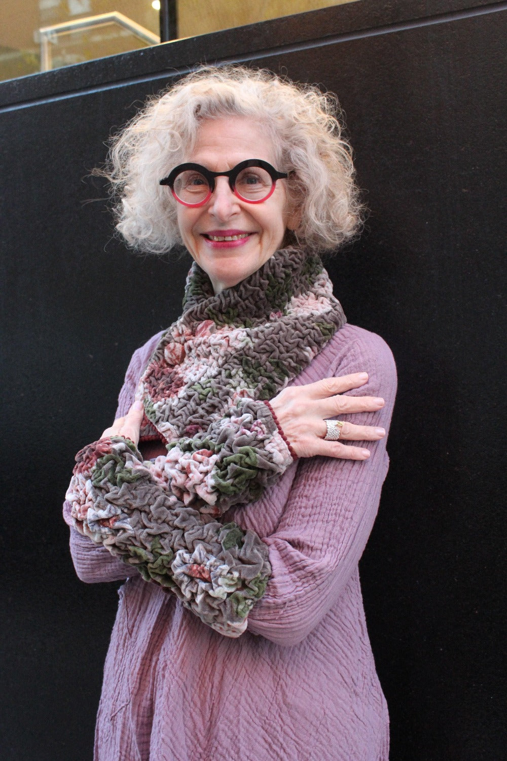 Crinkle Collar Scarf in a floral ecru color being worn with matching crinkle fingerless cuffs.