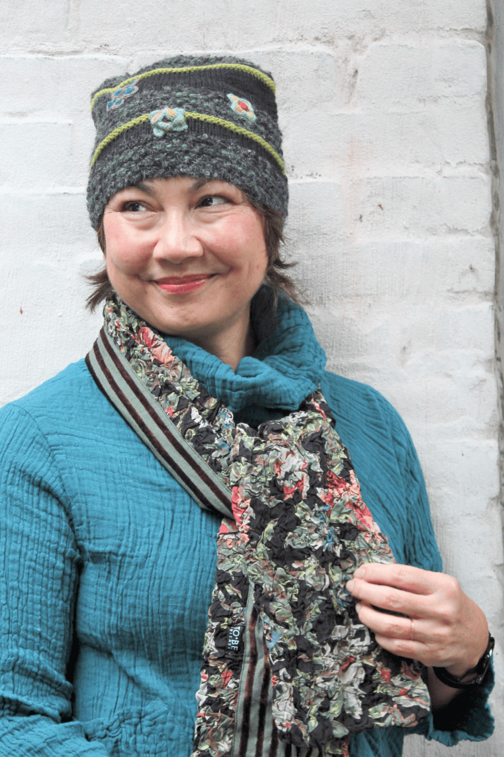 Crinkle Velvet Scarf with hat and scarf being worn on a smiling woman.