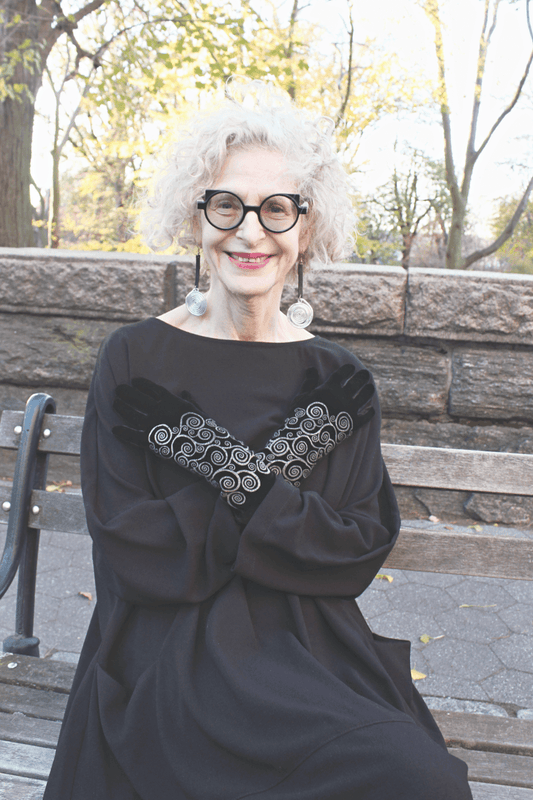 Black Silver Klimt Velvet Gloves being worn on a smiling older woman.