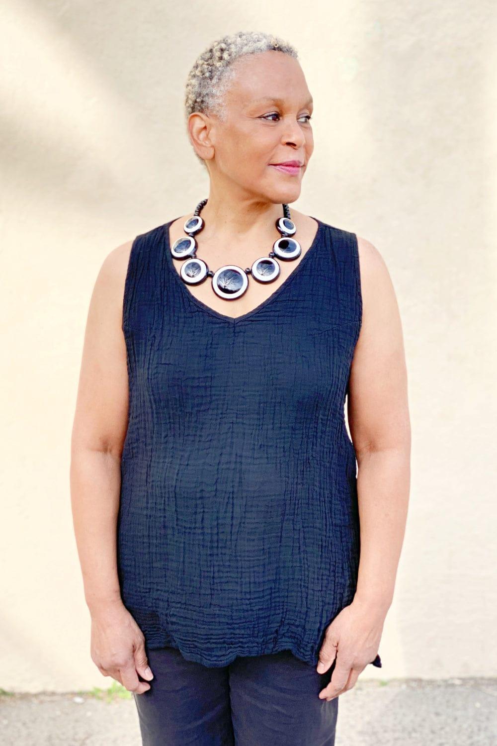 Woman wearing a Black Cotton Crinkle Tank with a disc bead shape necklace.