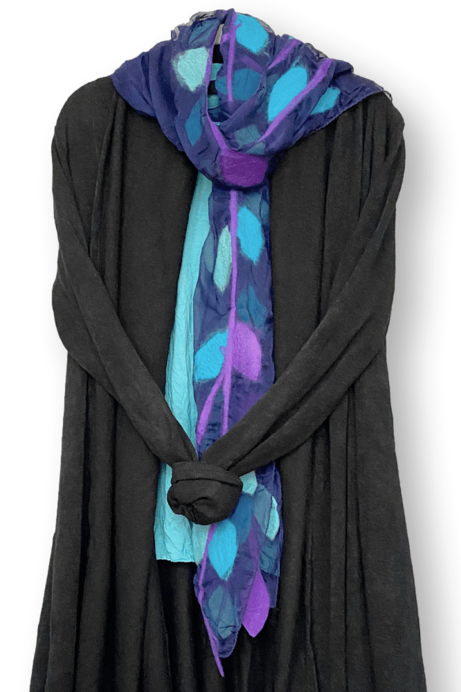 Merino Wool and Silk Chiffon Scarf designed in a leaf motif. Pretty purples and blues styled over a long black sweater.