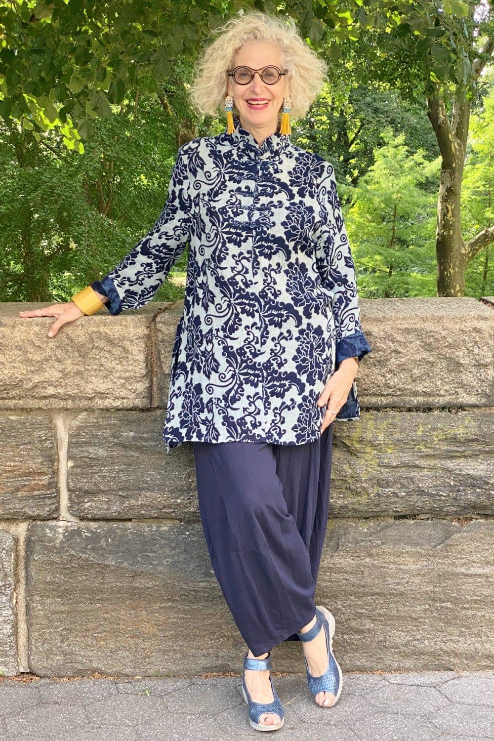 Double cotton gauze indigo print tunic being worn by an older smiling woman. She is wearing fun tassle earings and a chunky mustard colored bracelet.