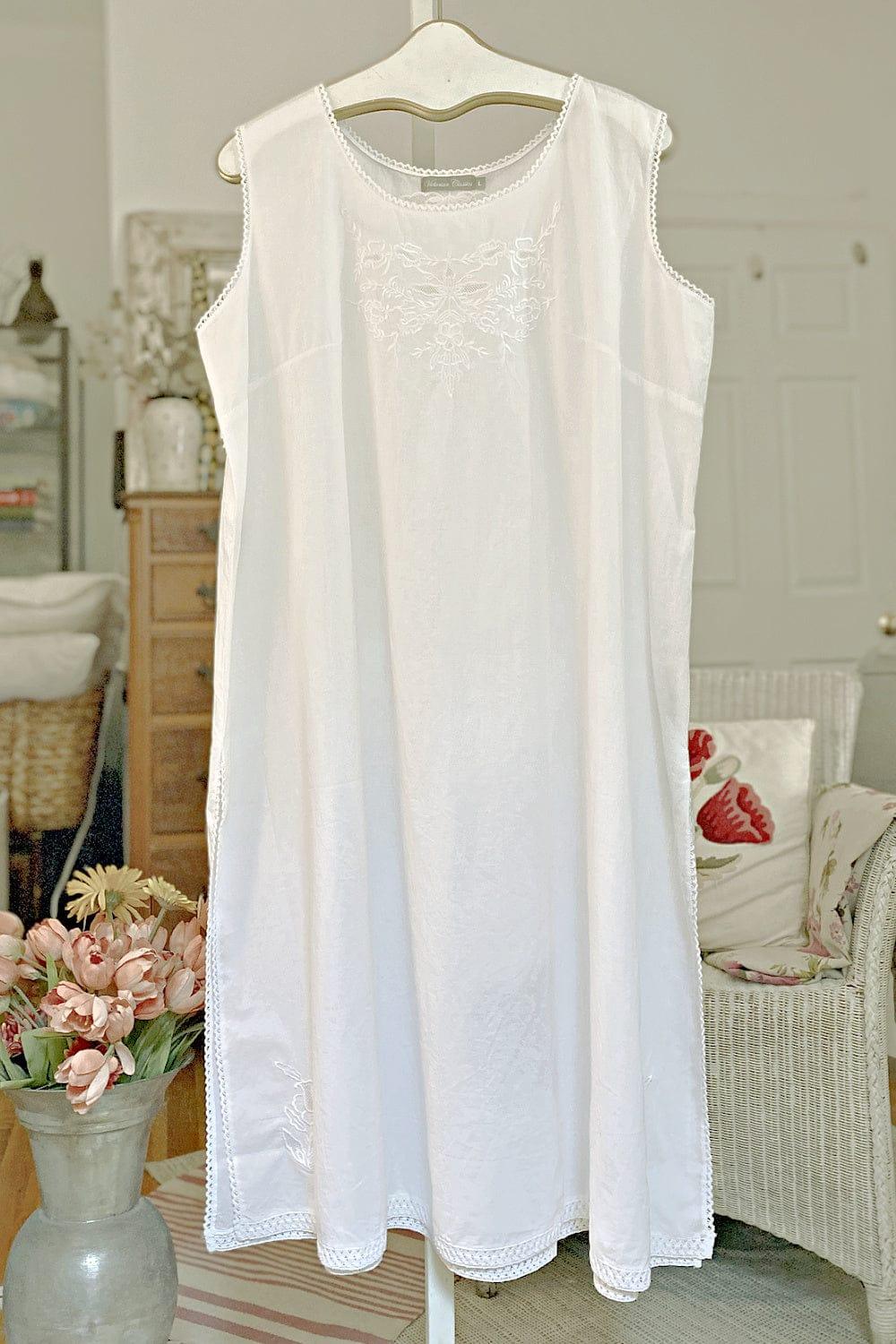 Cotton Sleeveless Mid Calf length white nightgown with decorative front and a round neckline.