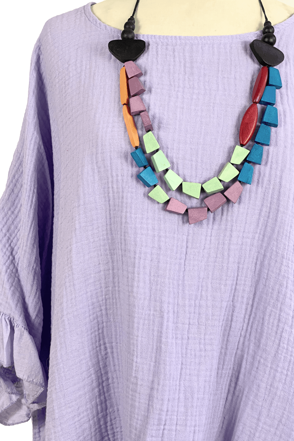 Pretty women's necklace in multiple colors styled over a soft lavender cotton top. 