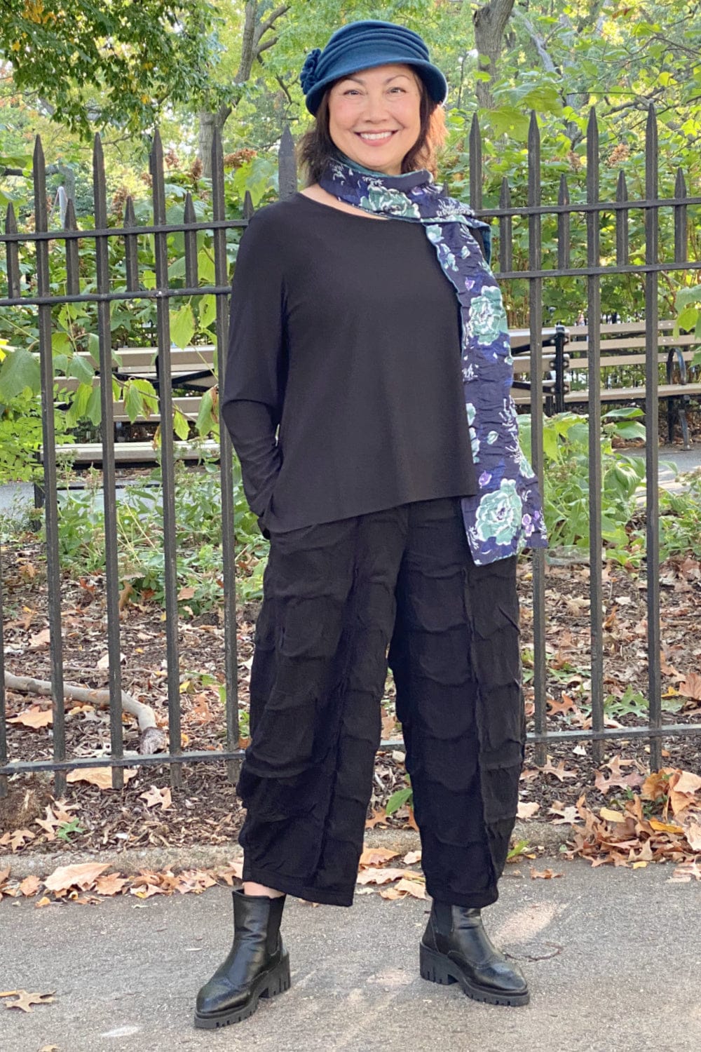 Women's Textured loose fit black pants styled with a blue hat and scarf.