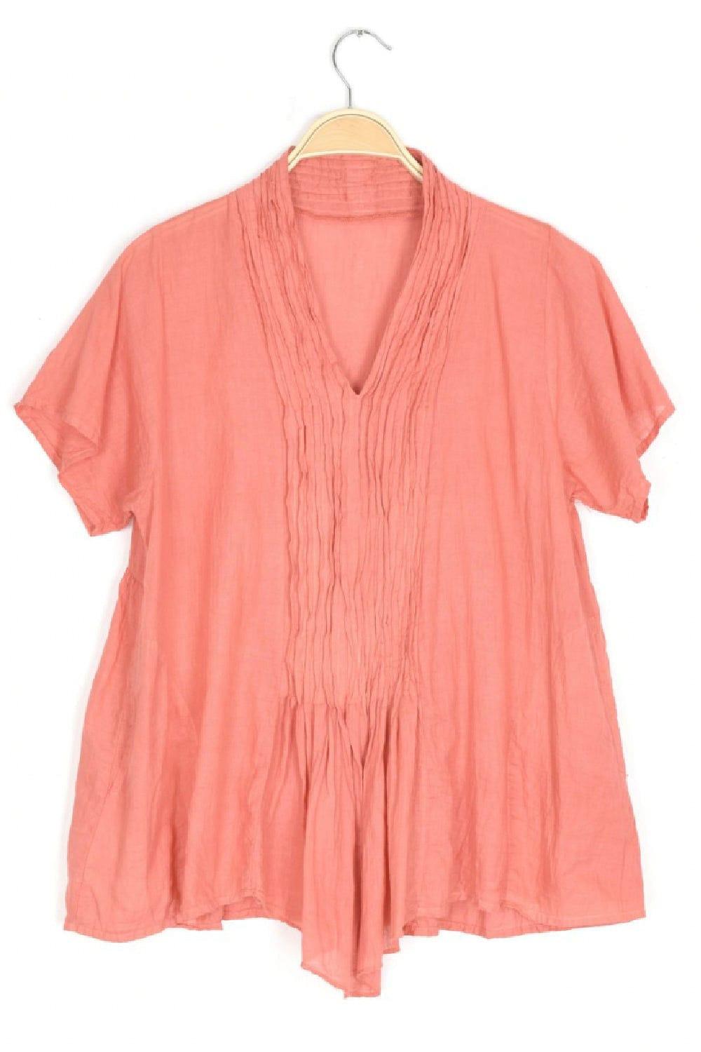 Coral short sleeve cotton blouse with front pleating.