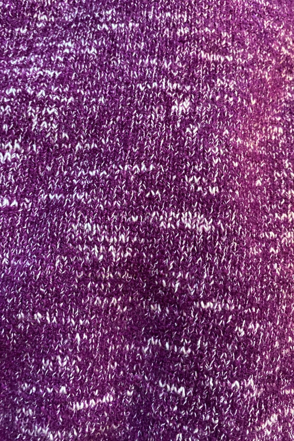 Plum with white fleck closeup of knit sweater.