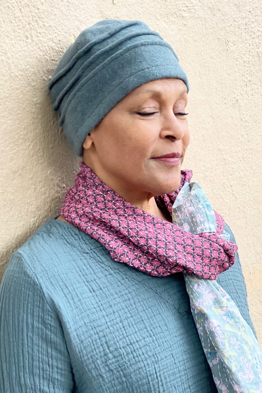 Forest blue green wool cloche hat being worn with a pink and blue kantha scarf.