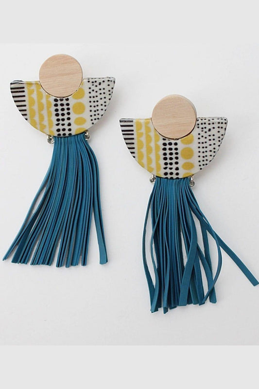 Teal tassel pierced earrings with a half circle decoupaged with a yellow and black dot pattern. 