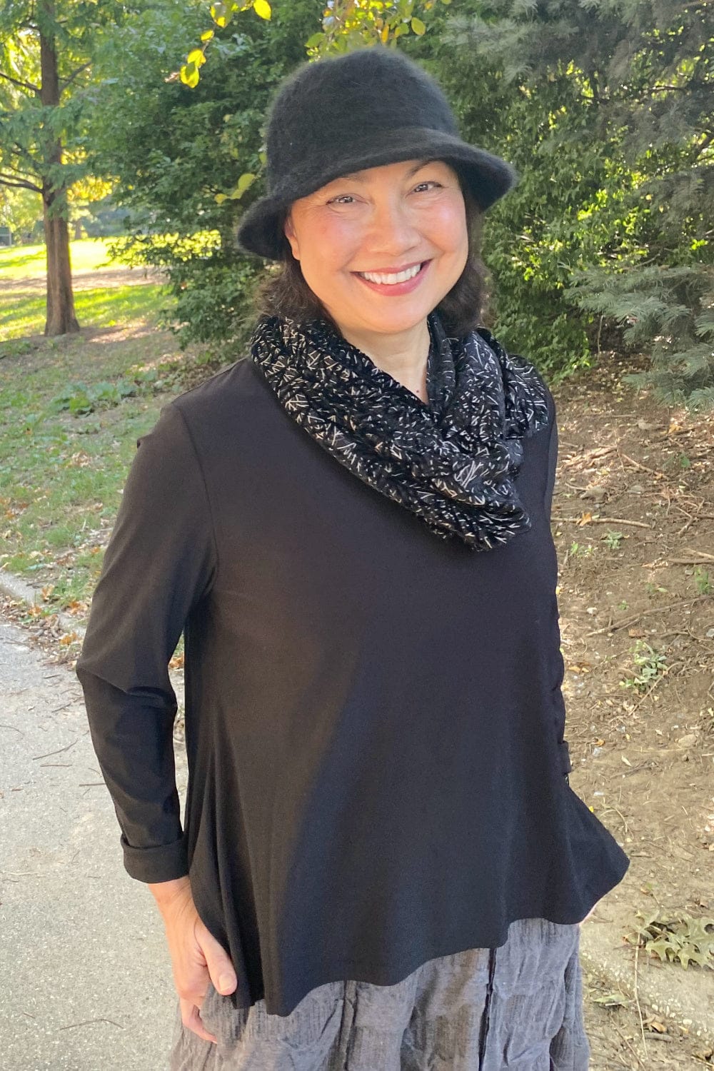 Basic black long sleeve tee styled with a velvet black and white scarf and angora hat.