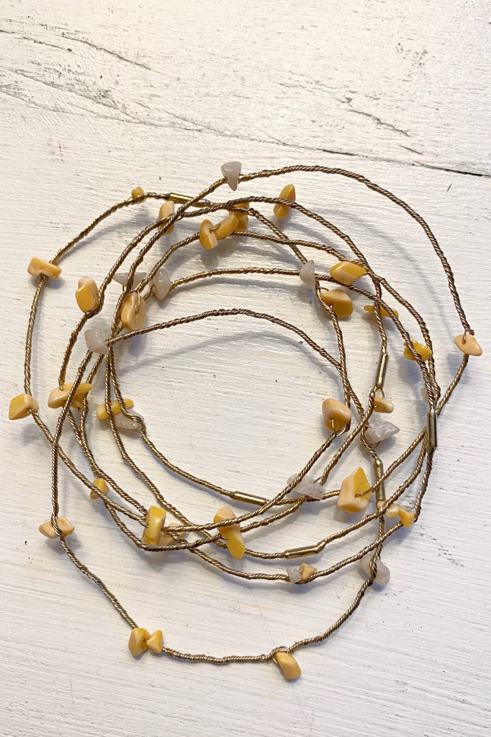Light gold colored brass twisted wire bracelets embellished with tiny carmel colored stones.