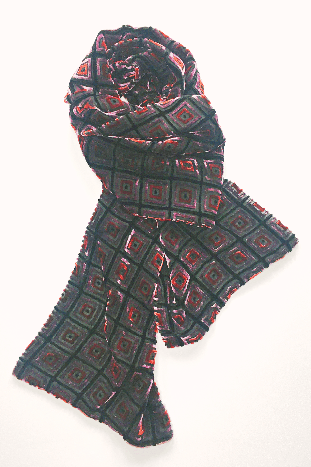 Cut Velvet Scarf in a pink, red and black squares pattern.